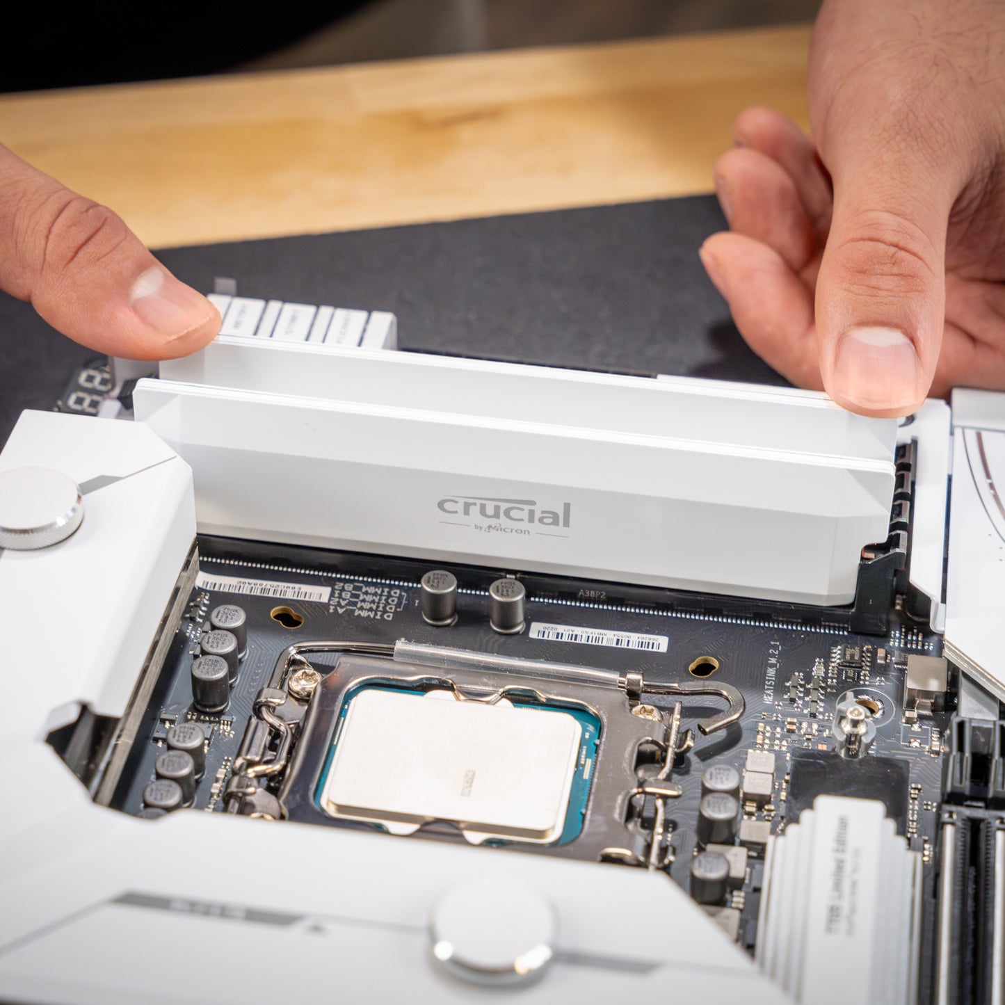 Crucial Pro Overclocking 16GB DDR5 6400MHz UDIMM CL38 Desktop Memory – White High-Speed RAM being installed on a motherboard.