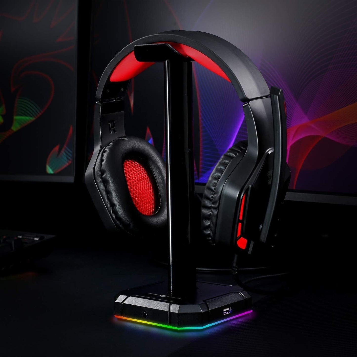 Redragon HA300 Scepter Pro RGB Headset Stand with USB Hub (4 x USB 2.0, RGB Lighting) on a sleek workspace with ambient RGB lighting.