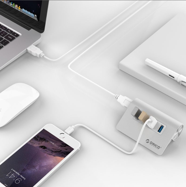4-Port USB 3.0 Hub by Orico – Durable Aluminum Housing connecting multiple devices to a laptop on a clean desk setup