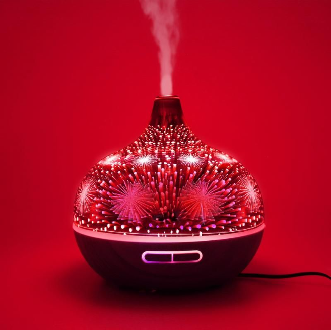 400ml Glass Aroma Diffuser with Firework Design featuring 3D lights and woodgrain base releasing soothing mist by Vitruvi.