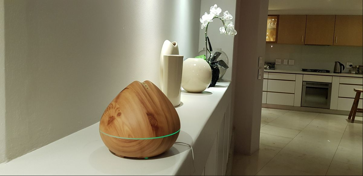 Atomiser: 400Ml Peach Light by Silkinder on white shelf with LED light, adding calm ambiance to modern kitchen space.