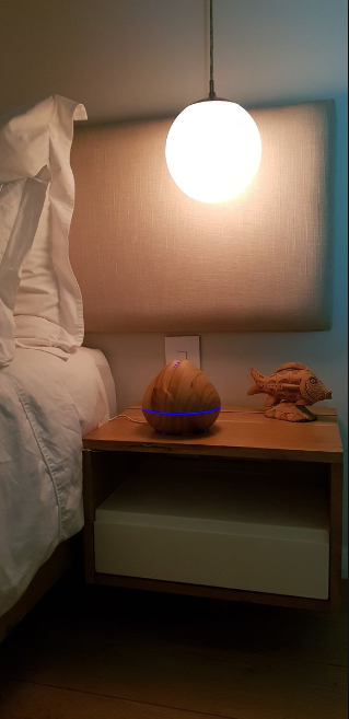 Atomiser: 400Ml Peach Light on bedside table with LED light creating a calming, soothing mist for air purification.