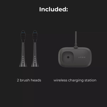 Two black toothbrushes and a wireless charging station on a black background with text indicating included items.