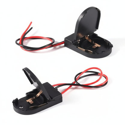 Front view of the M-Link CR2032 battery holder with its switch and wire leads.

