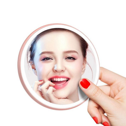 LED Portable Makeup Mirror with Built-in Wireless Charger - Rose Gold held by hand with bright makeup reflection