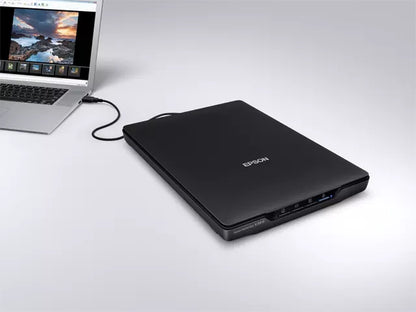 Epson Perfection V39II Photo and document scanner connected to a laptop, showcasing its sleek design and functionality.