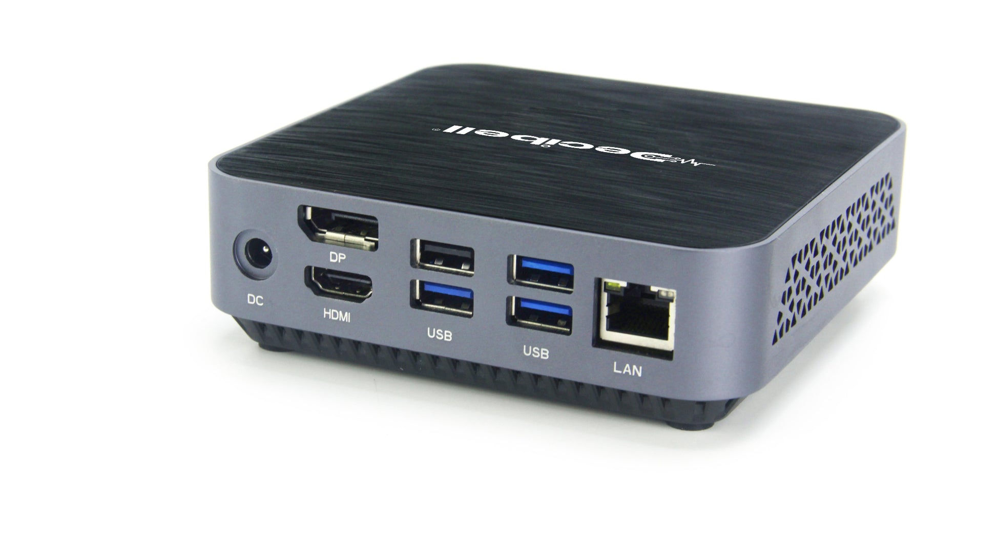 A compact desktop mini PC with a black textured top and a gray side panel, featuring multiple ports including USB, HDMI, DP, LAN, and DC, on a white background.