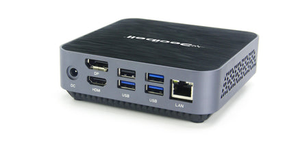 A compact desktop mini PC with a black textured top and a gray side panel, featuring multiple ports including USB, HDMI, DP, LAN, and DC, on a white background.
