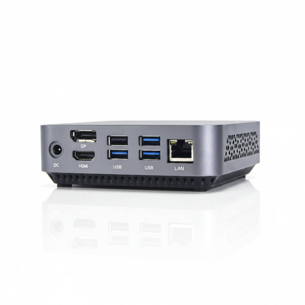 A compact silver mini PC or desktop computer shown from the rear, featuring multiple ports including DC, HDMI, USB, LAN, and DP on a clean white background.