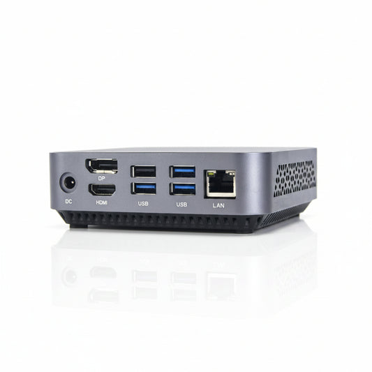 A compact silver mini PC or desktop computer shown from the rear, featuring multiple ports including DC, HDMI, USB, LAN, and DP on a clean white background.