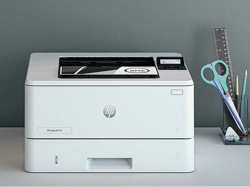 HP LaserJet Pro 4003Dn - High Speed Duplex Printing, compact white HP printer on desk with scissors and ruler